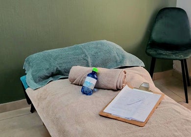 Cozy massage setup at Calmm Massage in Sandton, Gauteng, ZA featuring soft towels and relaxation essentials.