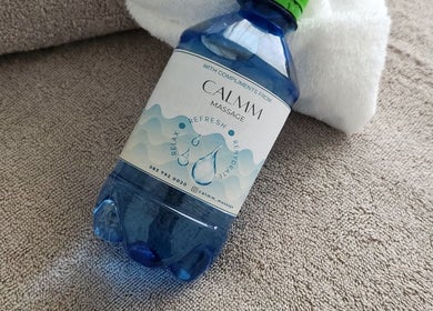 Complimentary water bottle on a towel at Calmm Massage, Sandton, Gauteng, ZA.