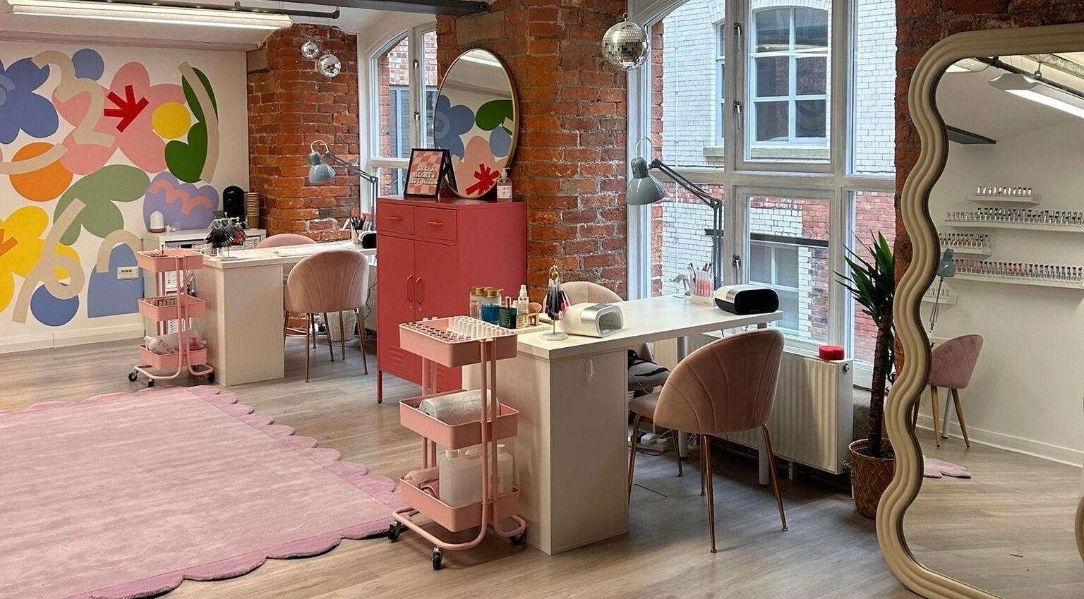 Gels by Maria salon interior in Manchester, England, GB featuring vibrant decor and stylish nail stations.
