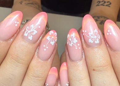 Floral nail art at Gels by Maria in Manchester, England, GB showcases delicate white flowers on pink nails.
