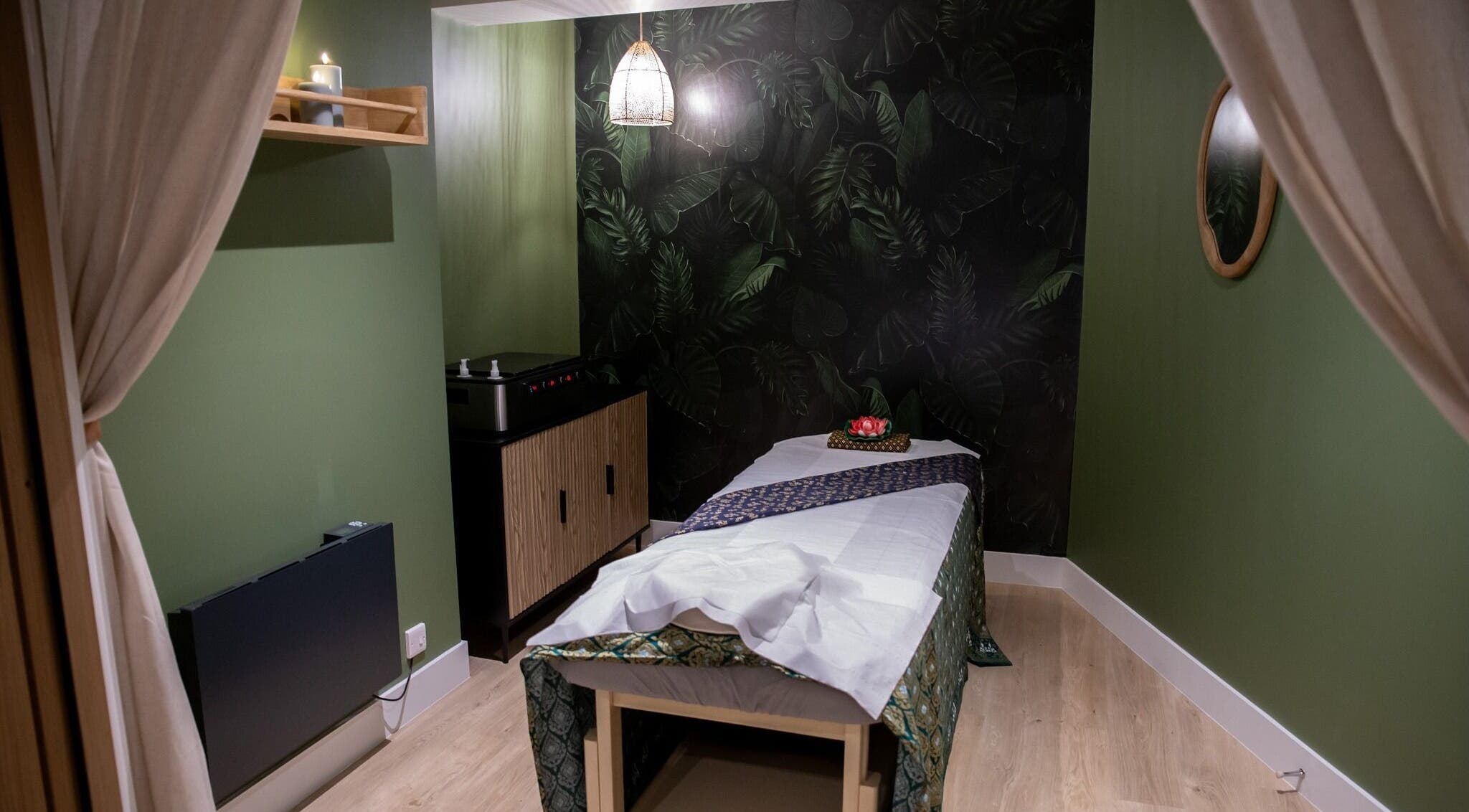 Tranquil massage room at Kimyra Thai Massage & Spa, Waltham Abbey, England, GB with lush green accents.
