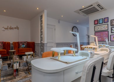 Elegant nail care station at J Belle Beauty in Bromley, England, GB, showcasing modern decor and seating.
