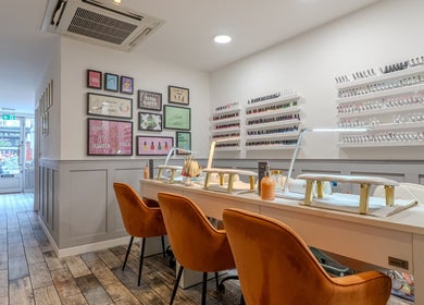 J Belle Beauty nail salon with orange chairs and nail polish display, Bromley, England, GB.
