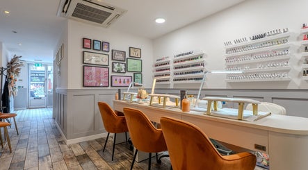 J Belle Beauty nail salon with orange chairs and nail polish display, Bromley, England, GB.