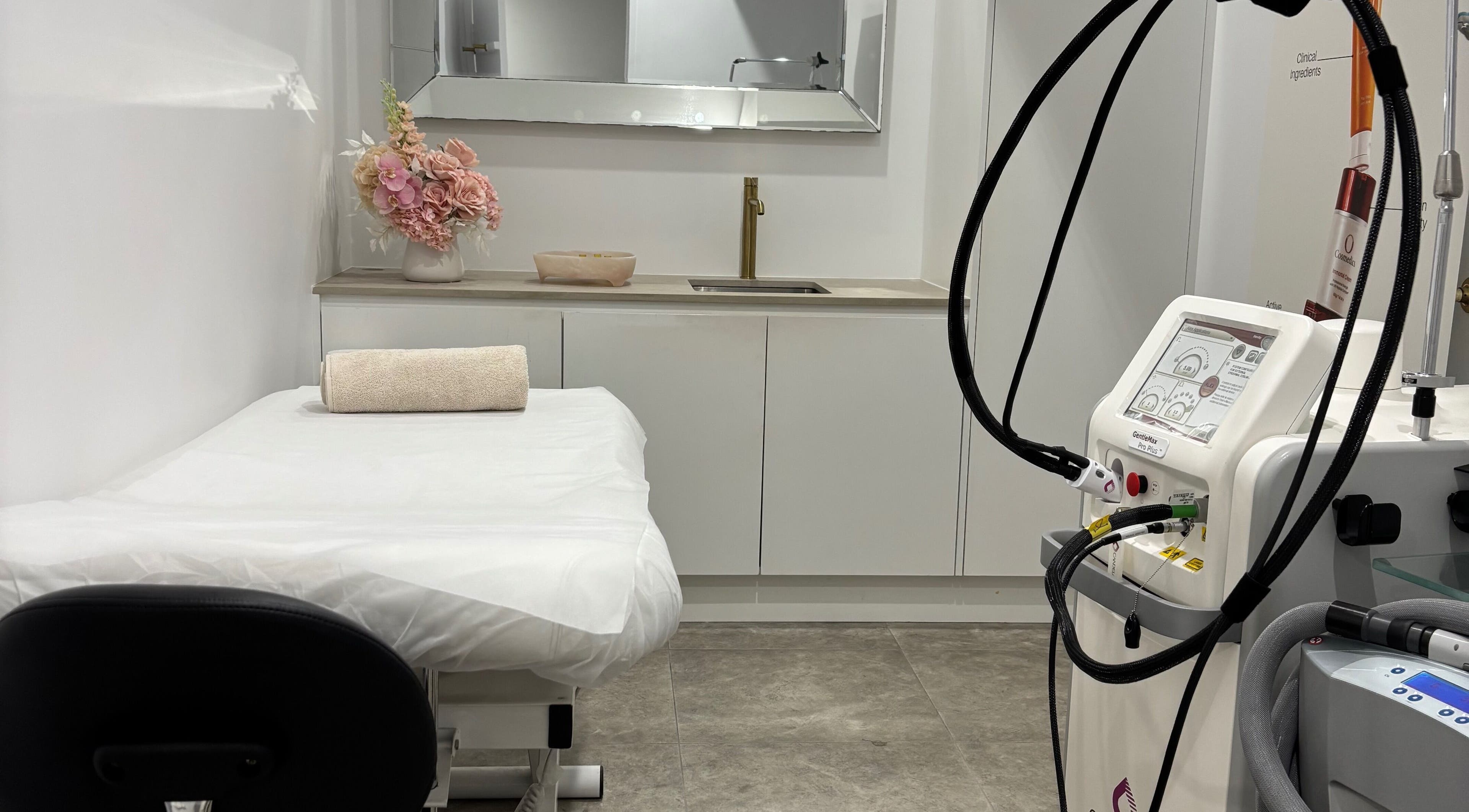 Relaxing treatment room at VIVID SKIN in Parramatta, New South Wales, AU with modern equipment and elegant decor.