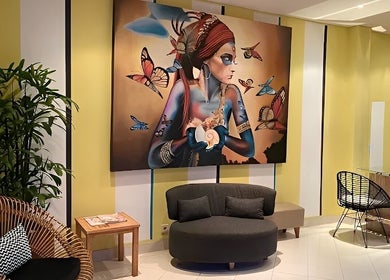Aspya Beauty & Wellness lounge in Bali, ID featuring vibrant mural and cozy seating.