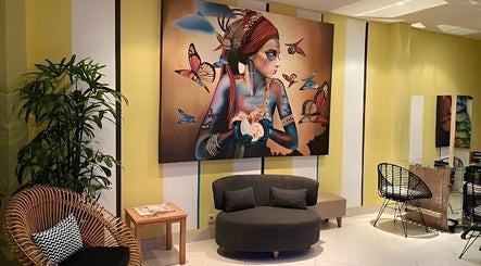 Aspya Salon & Wellness in Bali showcases a vibrant art-filled lounge with cozy seating.