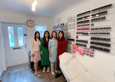 Team at My Beauty & Nails & Massage in Eynesbury, England, GB. Salon interior with nail polish display.