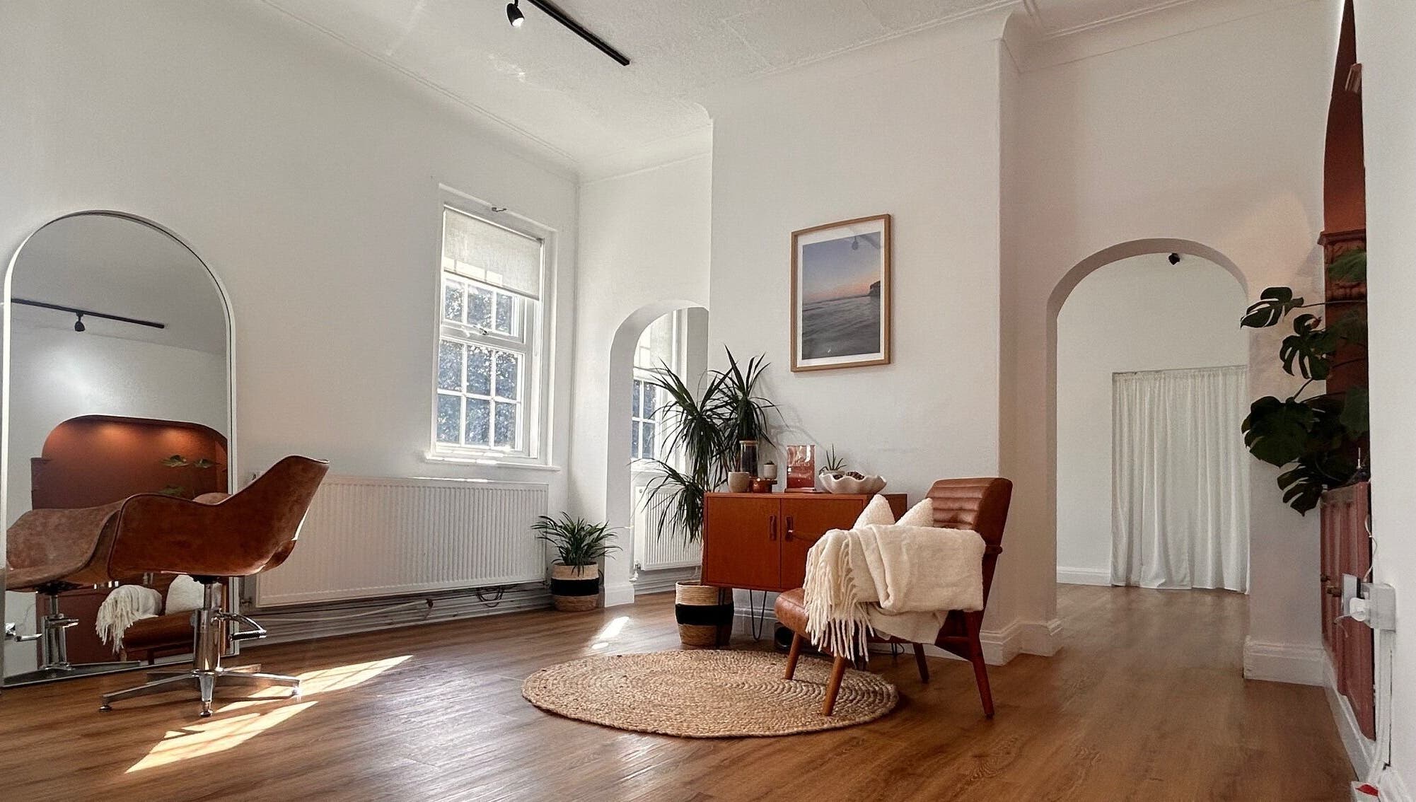 Stylish interior of Mantra Studio in Leeds, England, GB. Modern decor with leather chairs and wooden floors.