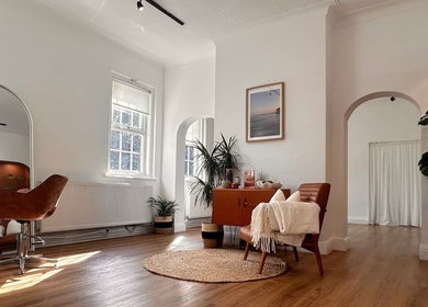 Stylish interior of Mantra Studio in Leeds, England, GB. Modern decor with leather chairs and wooden floors.