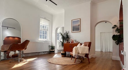 Stylish interior of Mantra Studio in Leeds, England, GB. Modern decor with leather chairs and wooden floors.