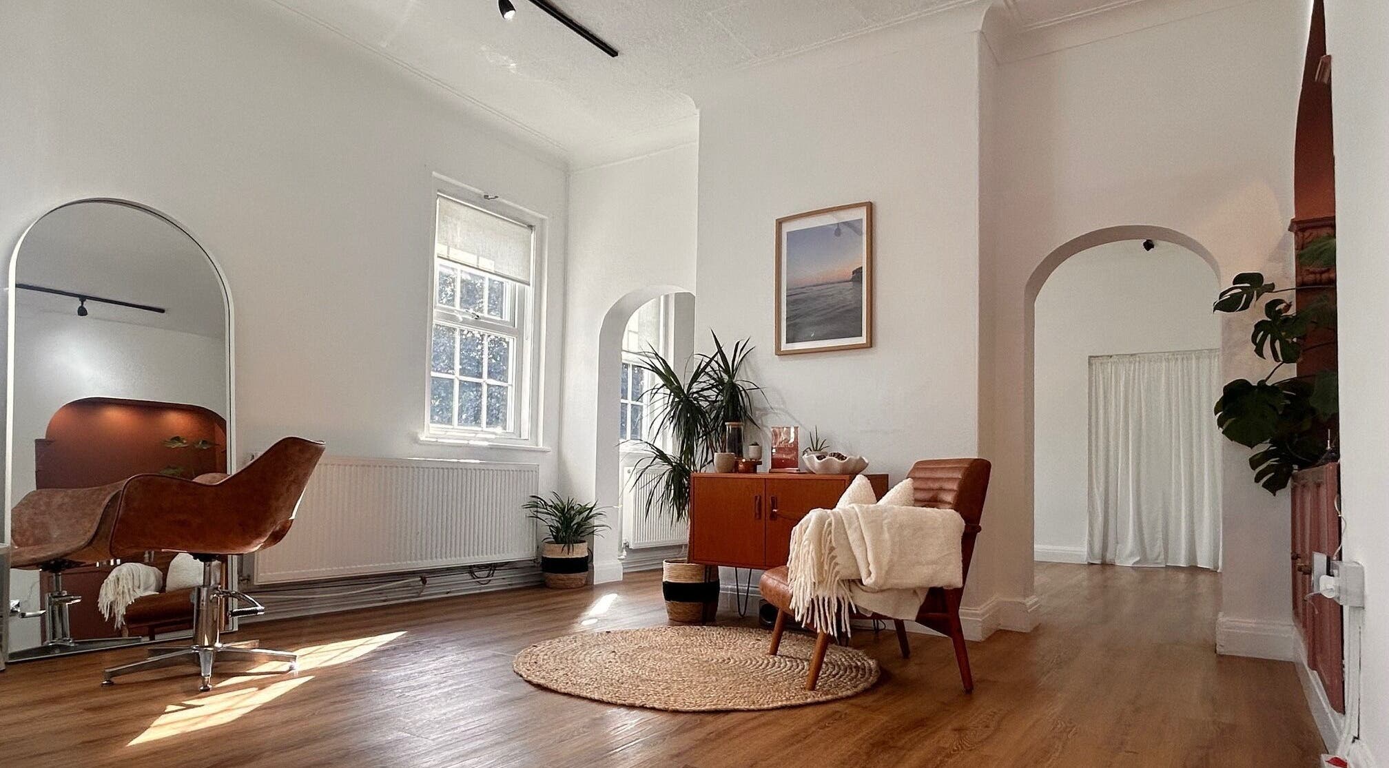 Stylish interior of Mantra Studio in Leeds, England, GB. Modern decor with leather chairs and wooden floors.