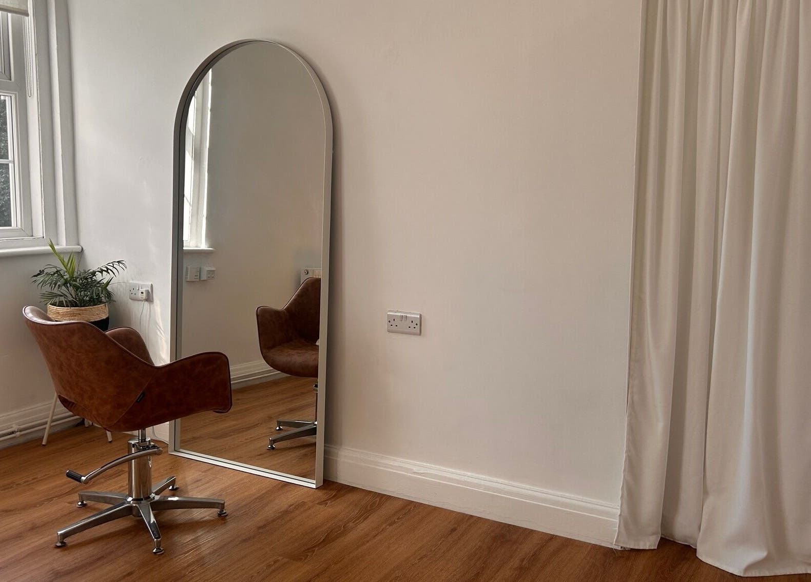 Cozy salon chair by mirror in Mantra Studio, Leeds, England, GB provides a tranquil beauty experience.