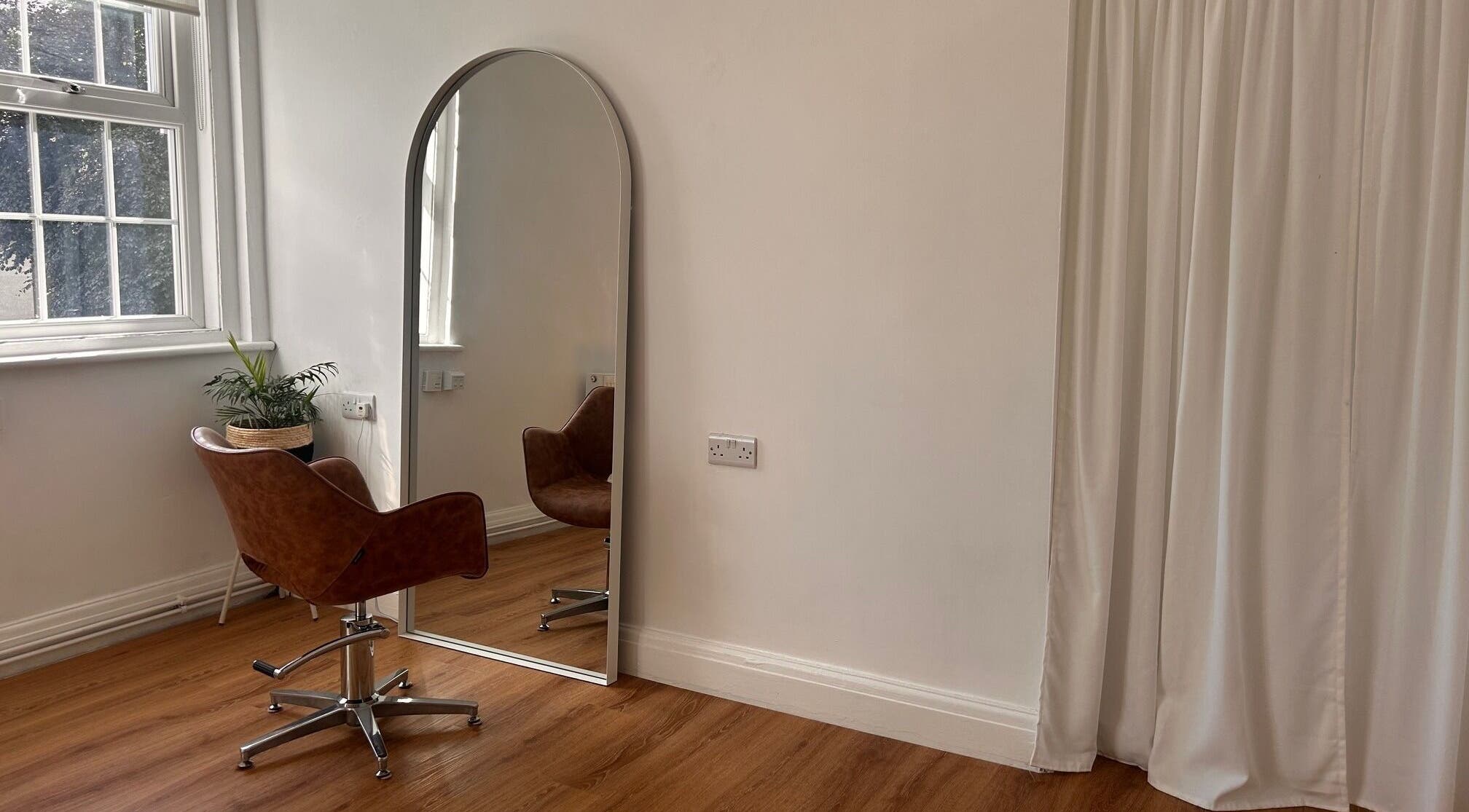 Cozy salon chair by mirror in Mantra Studio, Leeds, England, GB provides a tranquil beauty experience.