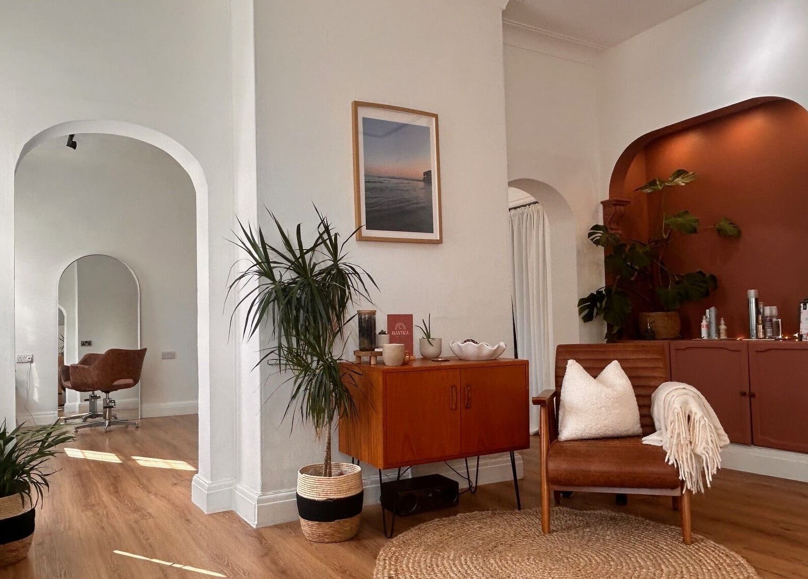 Cozy corner at Mantra Studio in Leeds, England, GB, featuring elegant decor with plants and seating.