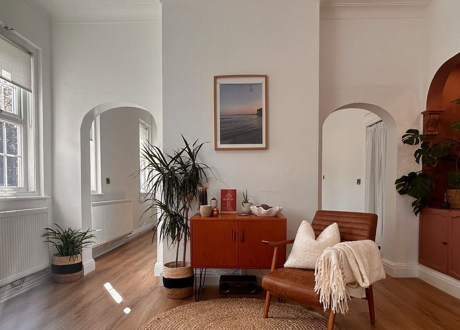 Serene lounge at Mantra Studio, Leeds, England, GB, with cozy chair, plants, and art piece on wall.
