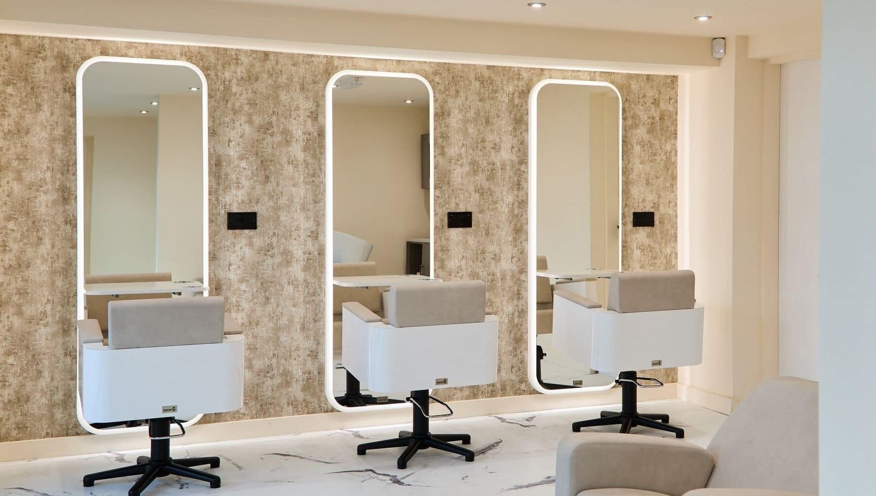Chic salon interior at Alysia Grimshaw Hair in Ramsbottom, England, GB, featuring stylish mirrors and seating.