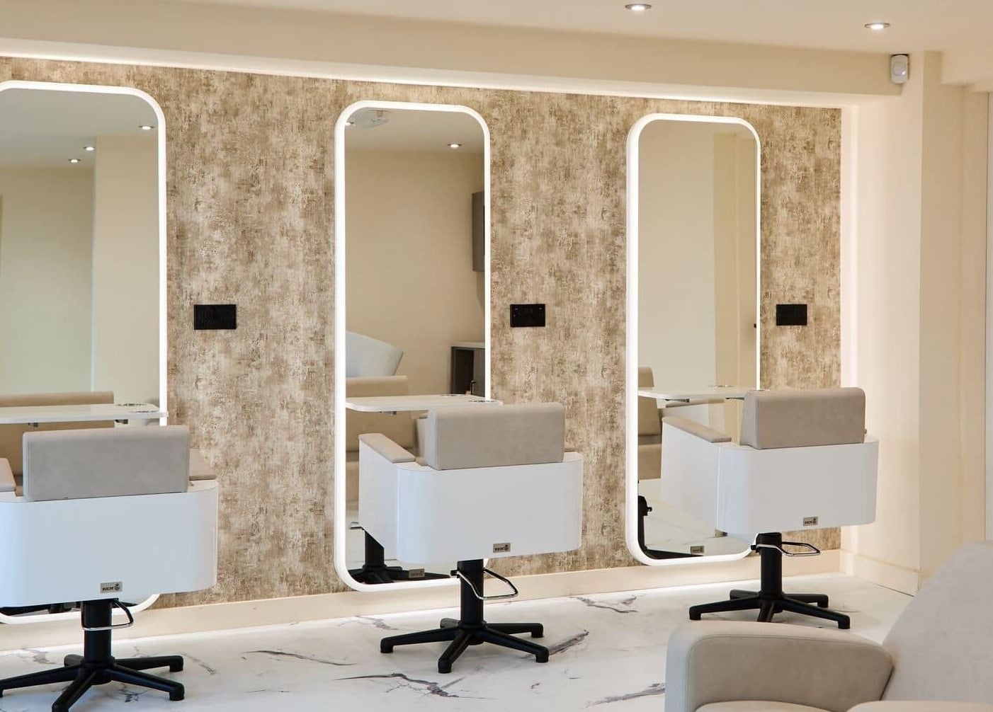 Chic salon interior at Alysia Grimshaw Hair in Ramsbottom, England, GB, featuring stylish mirrors and seating.