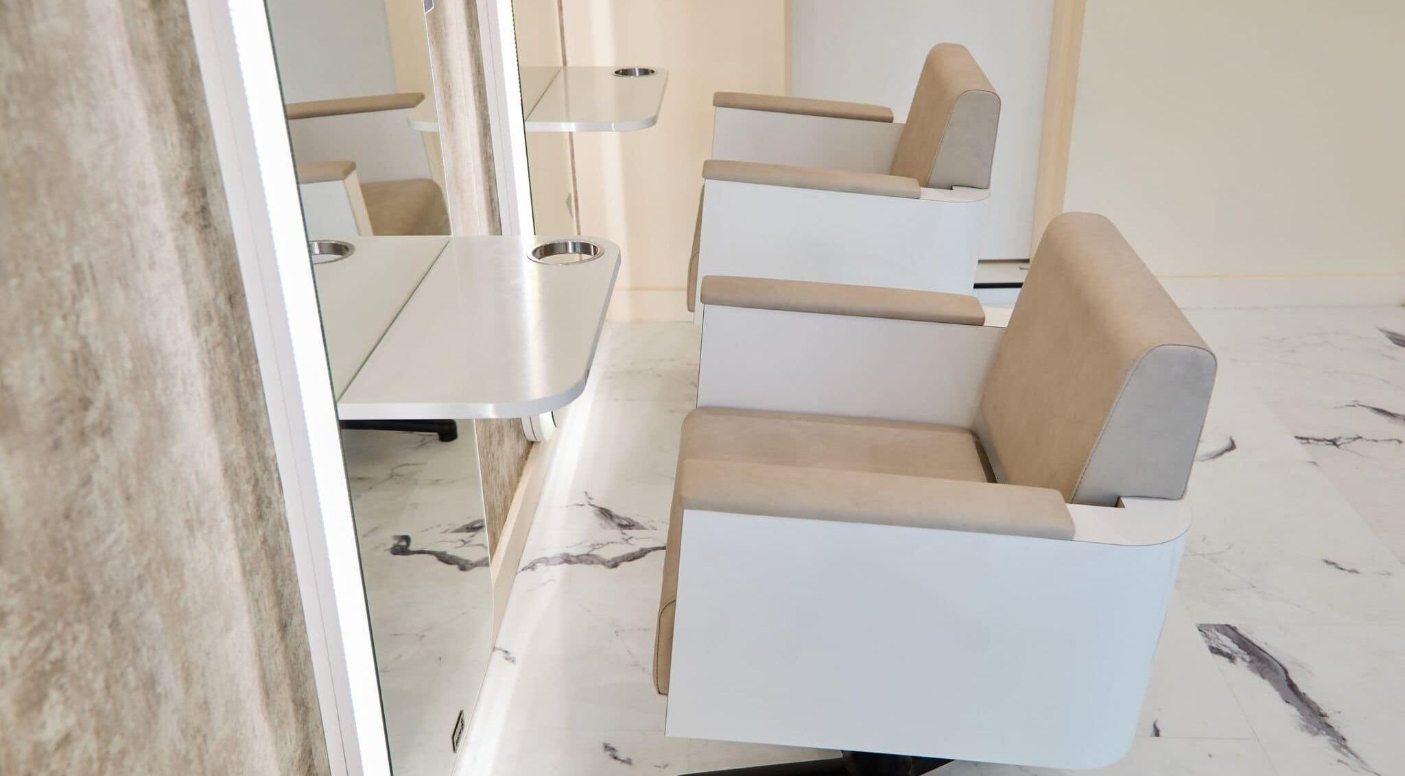 Modern salon chairs at Alysia Grimshaw Hair in Ramsbottom, England, GB featuring sleek design.