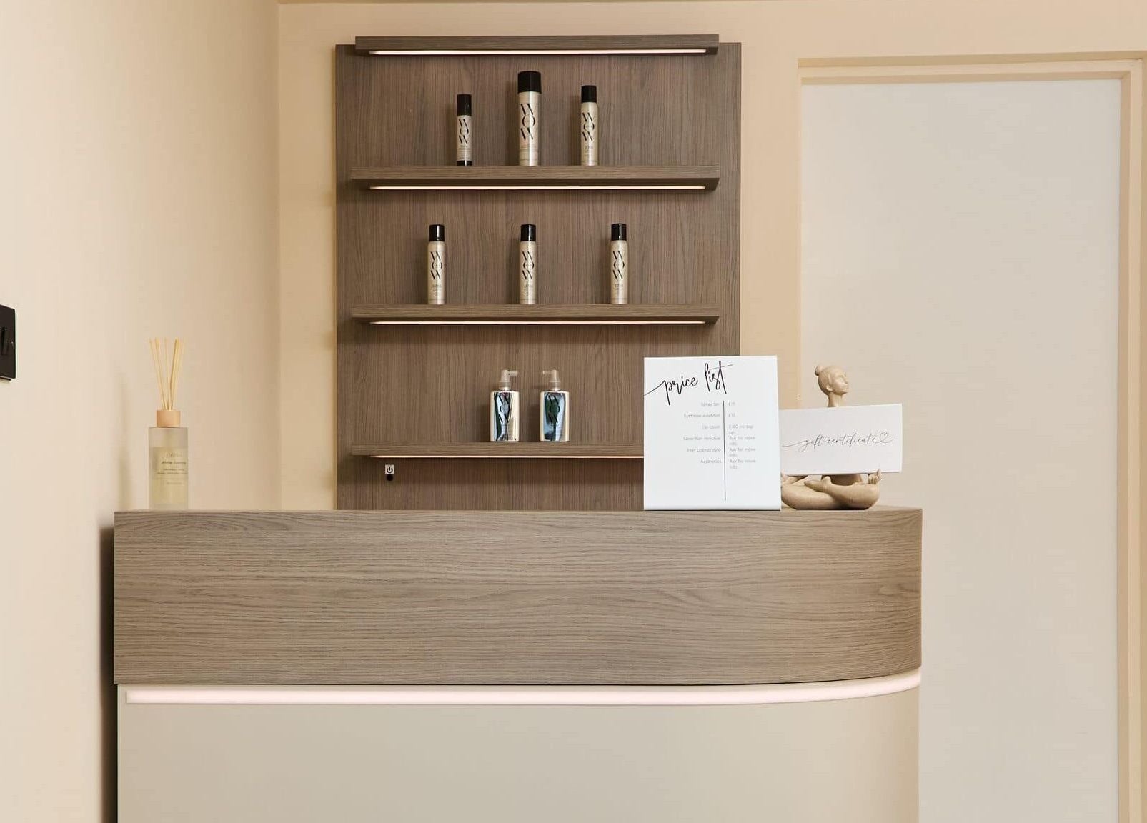 Reception area at Alysia Grimshaw Hair, Ramsbottom, England, GB with elegant shelves and products.