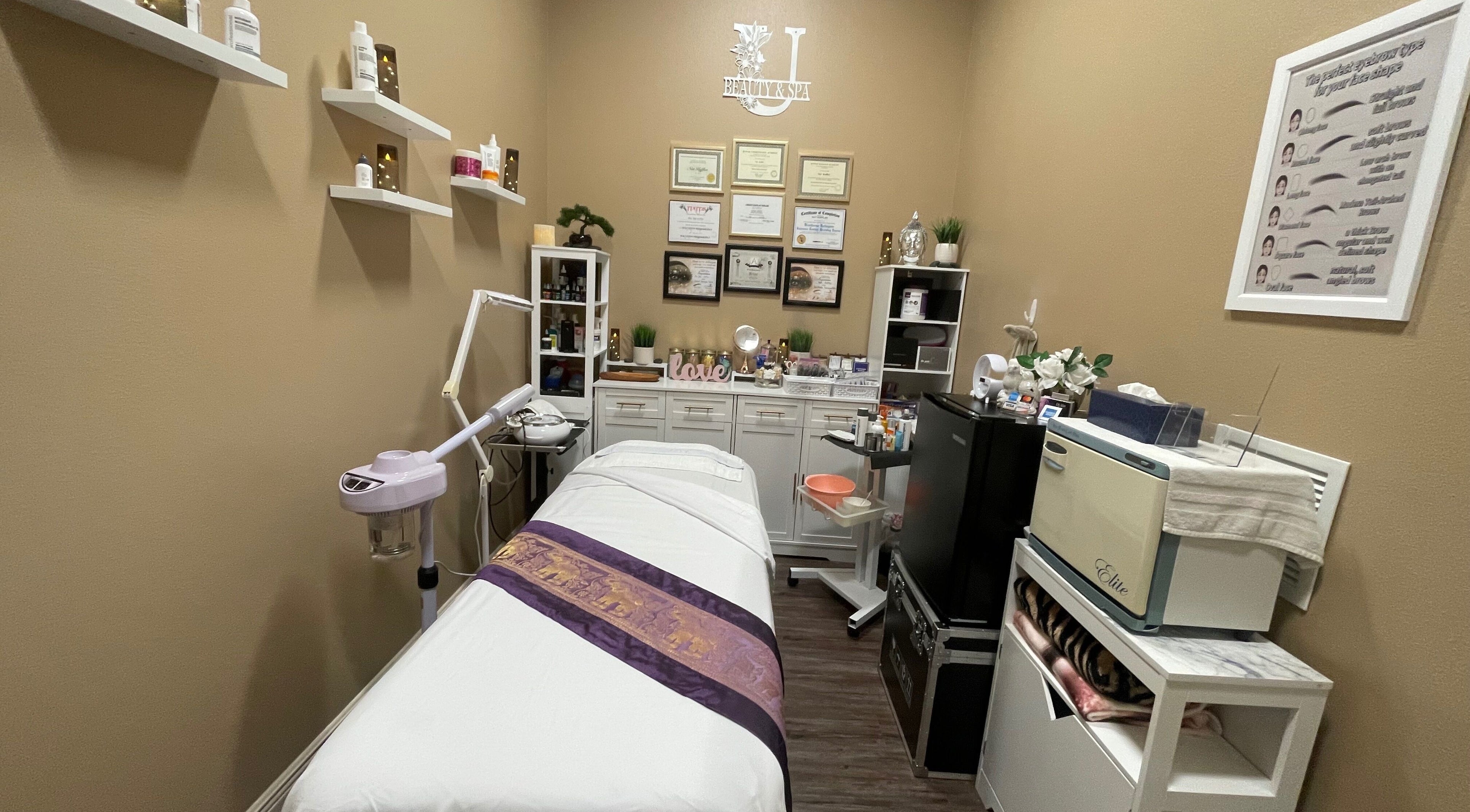 Cozy treatment room at U Beauty & Spa, Orlando, Florida, US, featuring a massage bed and elegant decor.