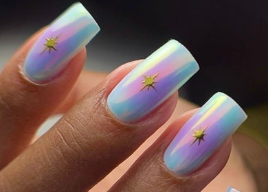 Holographic nails with star accents from ZnailsChicago, Chicago, Illinois, US, featuring a pastel gradient design.