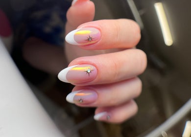 Stylish manicured nails with star accents at ZnailsChicago in Chicago, Illinois, US.