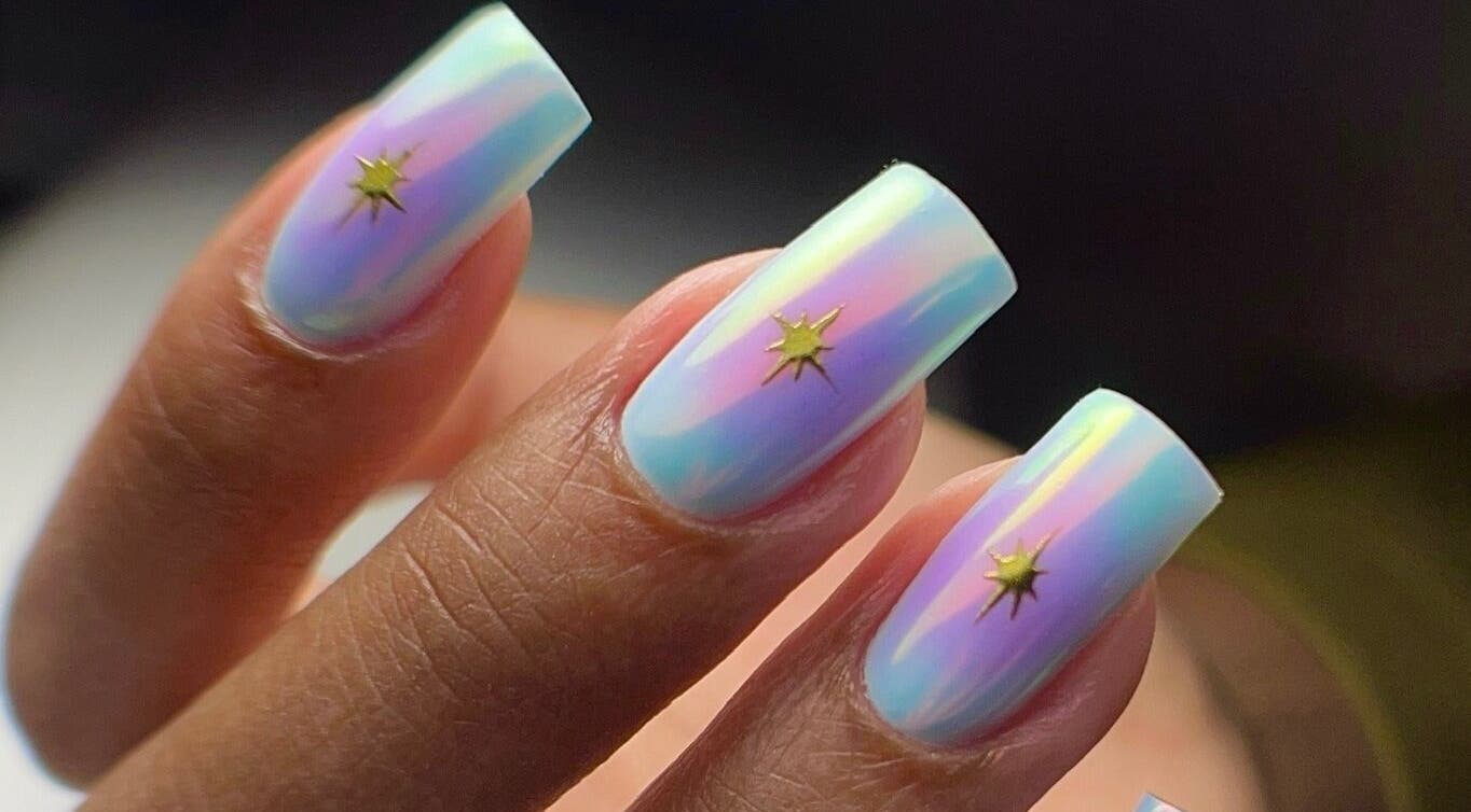 Iridescent nail art with star design at ZnailsChicago, Chicago, Illinois, US. Shimmering pastel hues.