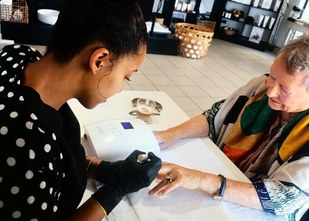 Manicure session at Y & Co. SKIN - HAIR - NAILS, Yzerfontein, Western Cape, ZA. Customer enjoys a relaxing treatment.