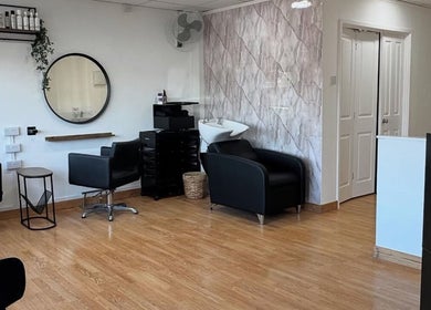 Modern interior of Flicks Hair Studio in Fareham, England, GB featuring stylish chairs and mirrors.