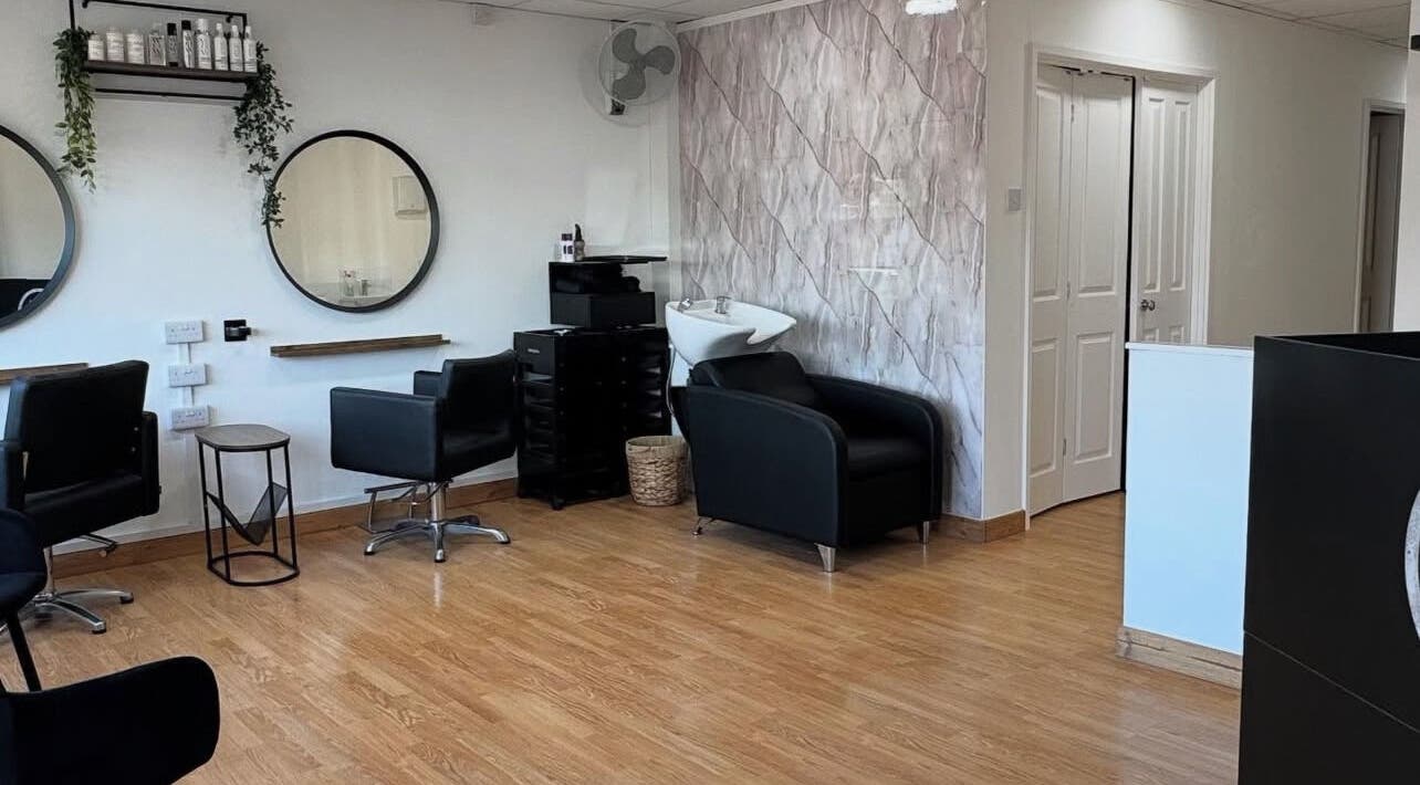 Modern interior of Flicks Hair Studio in Fareham, England, GB featuring stylish chairs and mirrors.
