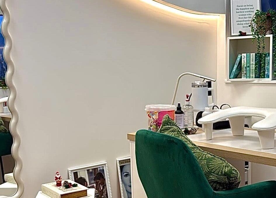 Chic styling station at The Pixie Studio, Cardiff, Wales, GB, featuring plush green chairs and elegant decor.