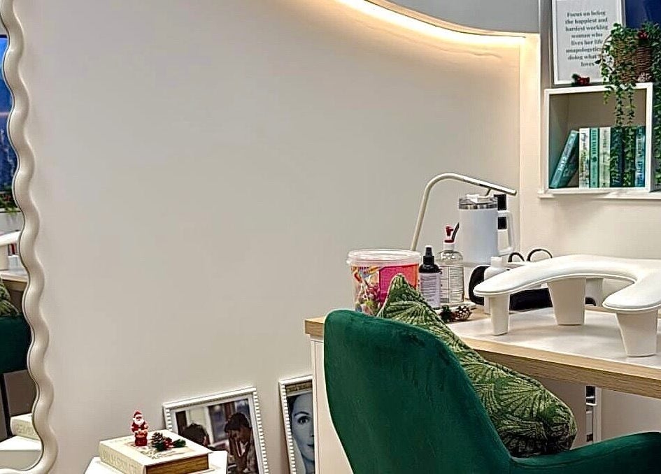 Chic styling station at The Pixie Studio, Cardiff, Wales, GB, featuring plush green chairs and elegant decor.
