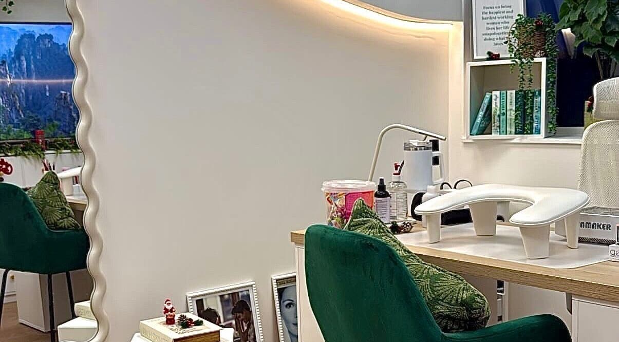 Chic styling station at The Pixie Studio, Cardiff, Wales, GB, featuring plush green chairs and elegant decor.