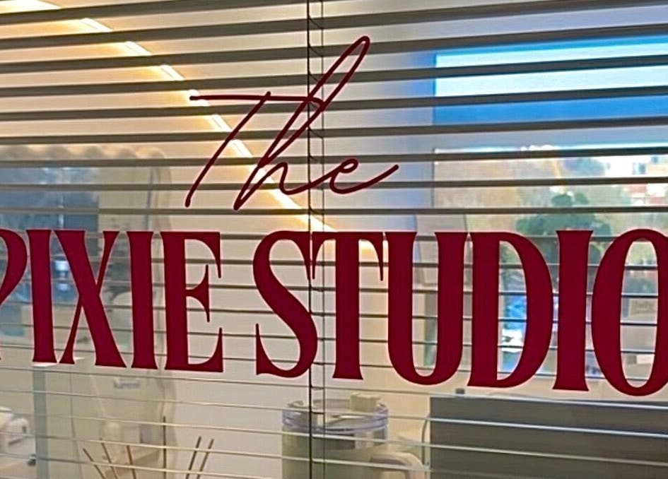 The Pixie Studio sign on window blinds in Cardiff, Wales, GB, adding elegance to the relaxation space.