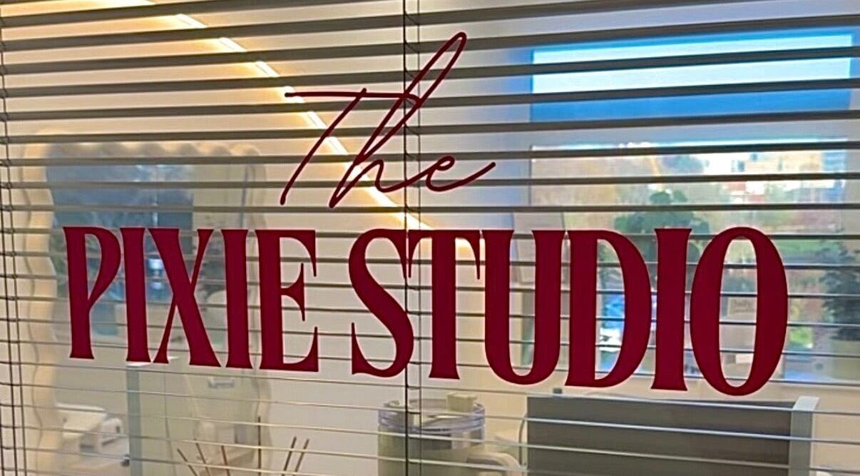 The Pixie Studio sign on window blinds in Cardiff, Wales, GB, adding elegance to the relaxation space.