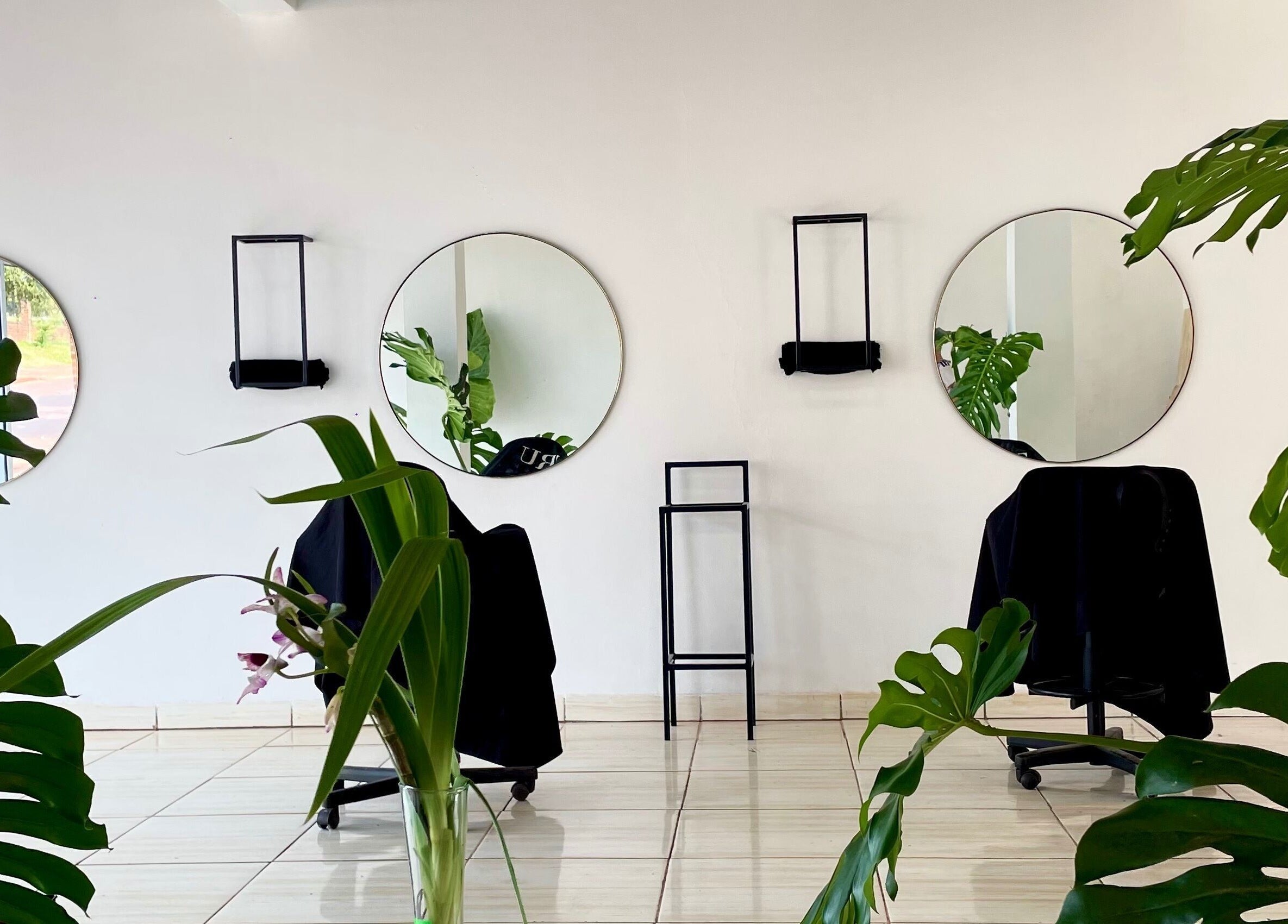 Elegante salón con espejos redondos en Jungle Instinct JS, Misiones, Misiones, AR, acentuado por plantas tropicales.