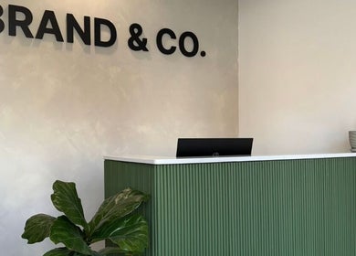 Reception area at Brand & Co., featuring greenery and modern decor in Philadelphia, Pennsylvania, US.