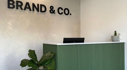 Reception area at Brand & Co., featuring greenery and modern decor in Philadelphia, Pennsylvania, US.