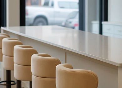 Elegant seating area at Brand & Co., Philadelphia, Pennsylvania, US, showcasing plush chairs and sleek countertops.
