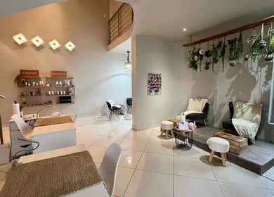 Refined Artistry lounge with cozy seating and greenery in Centurion, Gauteng, ZA.