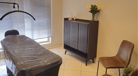 Refined Artistry's serene treatment room in Centurion, Gauteng, ZA, featuring a sleek table and elegant decor.