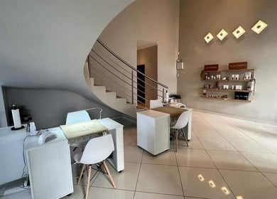 Modern interior of Refined Artistry in Centurion, Gauteng, ZA, featuring sleek spiral staircase and minimalist decor.