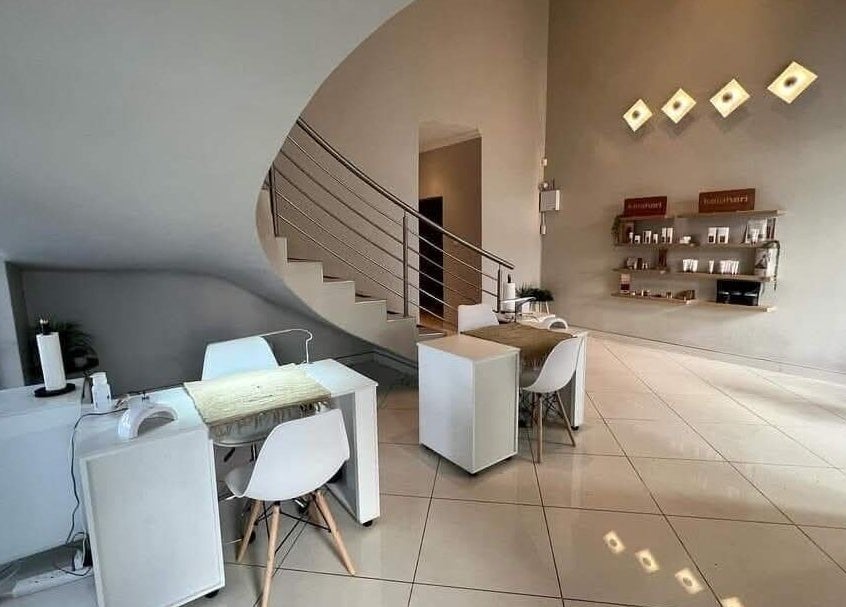 Modern interior of Refined Artistry in Centurion, Gauteng, ZA, featuring sleek spiral staircase and minimalist decor.
