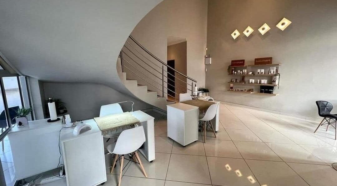 Modern interior of Refined Artistry in Centurion, Gauteng, ZA, featuring sleek spiral staircase and minimalist decor.