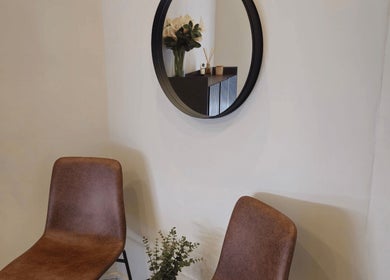 Stylish seating area with mirror and decor at Refined Artistry, Centurion, Gauteng, ZA.