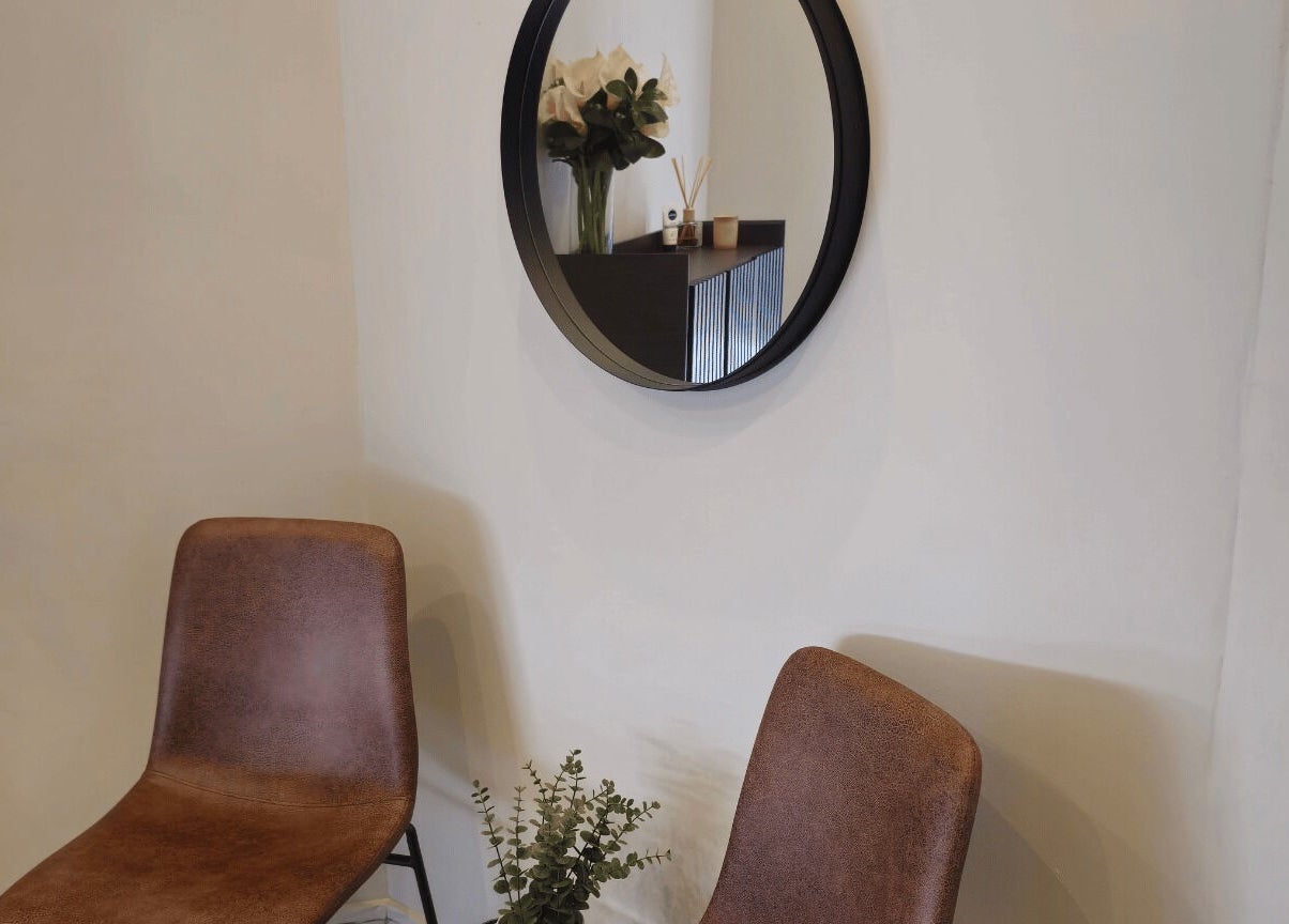 Stylish seating area with mirror and decor at Refined Artistry, Centurion, Gauteng, ZA.