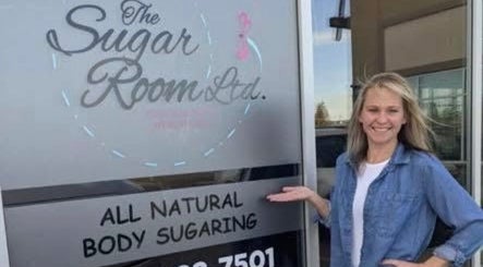 Smiling person outside The Sugar Room Okotoks, a body sugaring venue in Okotoks, Alberta, CA.
