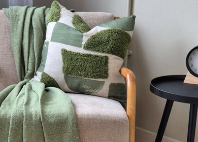 Elegant lounge chair with a green throw and cushion at Sj Studio, Durban, Kwazulu-natal, ZA.