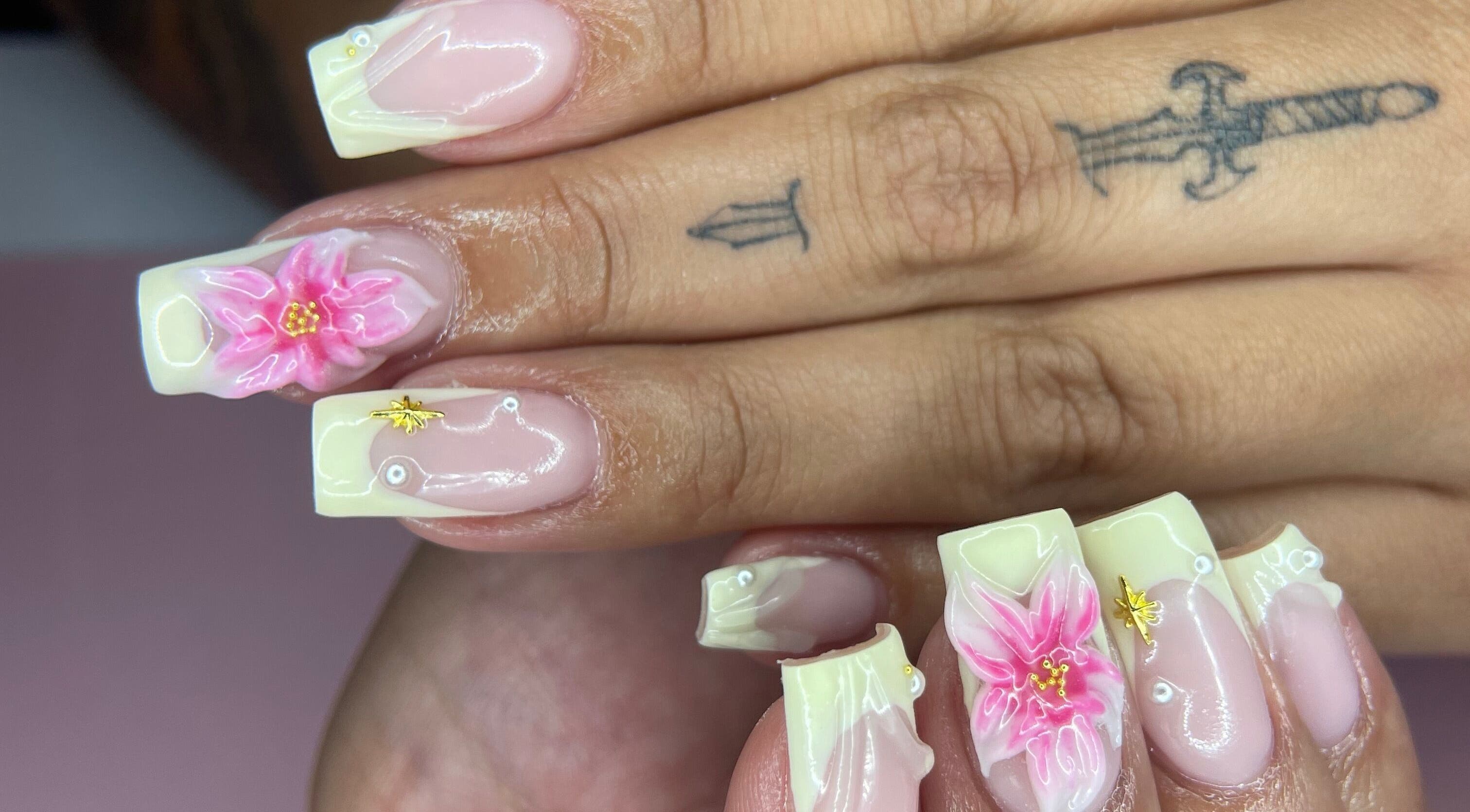 Beautiful floral nail art at studio3esthetics, Thunder Bay, Ontario, CA, showcasing delicate pink petals.